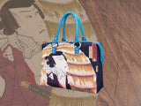 “Actor Kawarazaki Gonjuro I, as Obo Kichiza” (豊国漫画図絵　おぼう吉三), a Ukiyo-e masterpiece by Utagawa Kunisada (歌川 国貞), showcased in detail on high-end handbag via video.